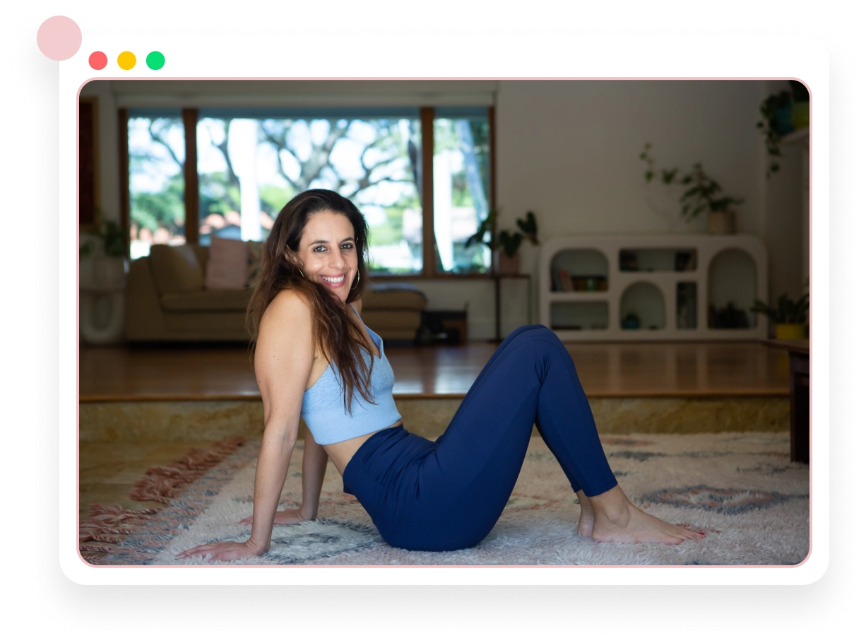 Lauren Ohayon seated on a rug, home interior with plants