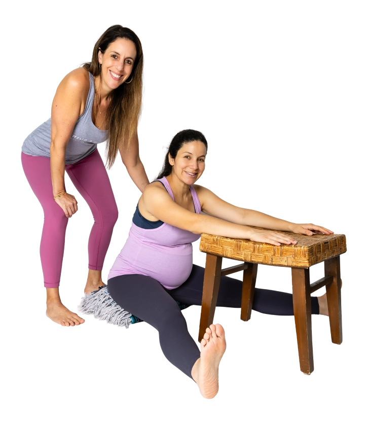 A pregnant woman receiving hands-on bodywork from an RYC® teacher