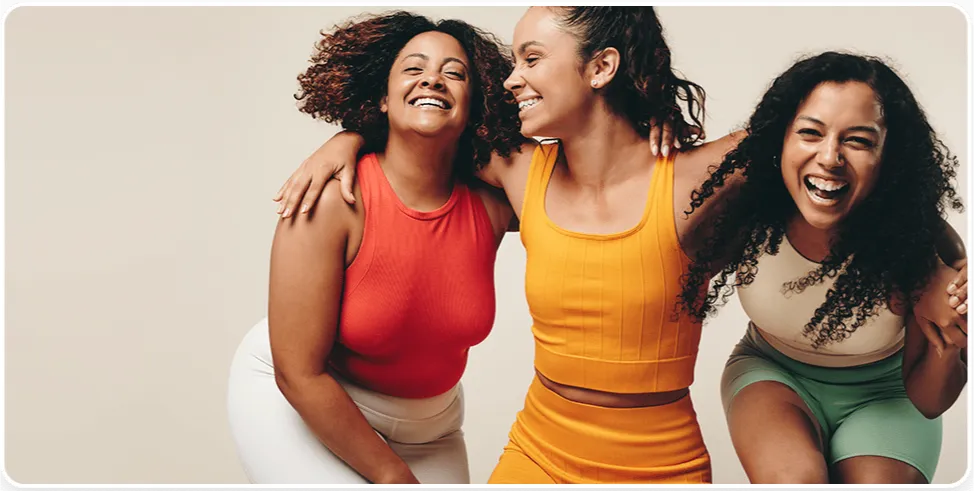 Three women laughing together after a Restore Your Core session