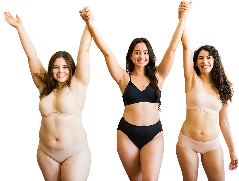 Three smiling women celebrating with their arms raised